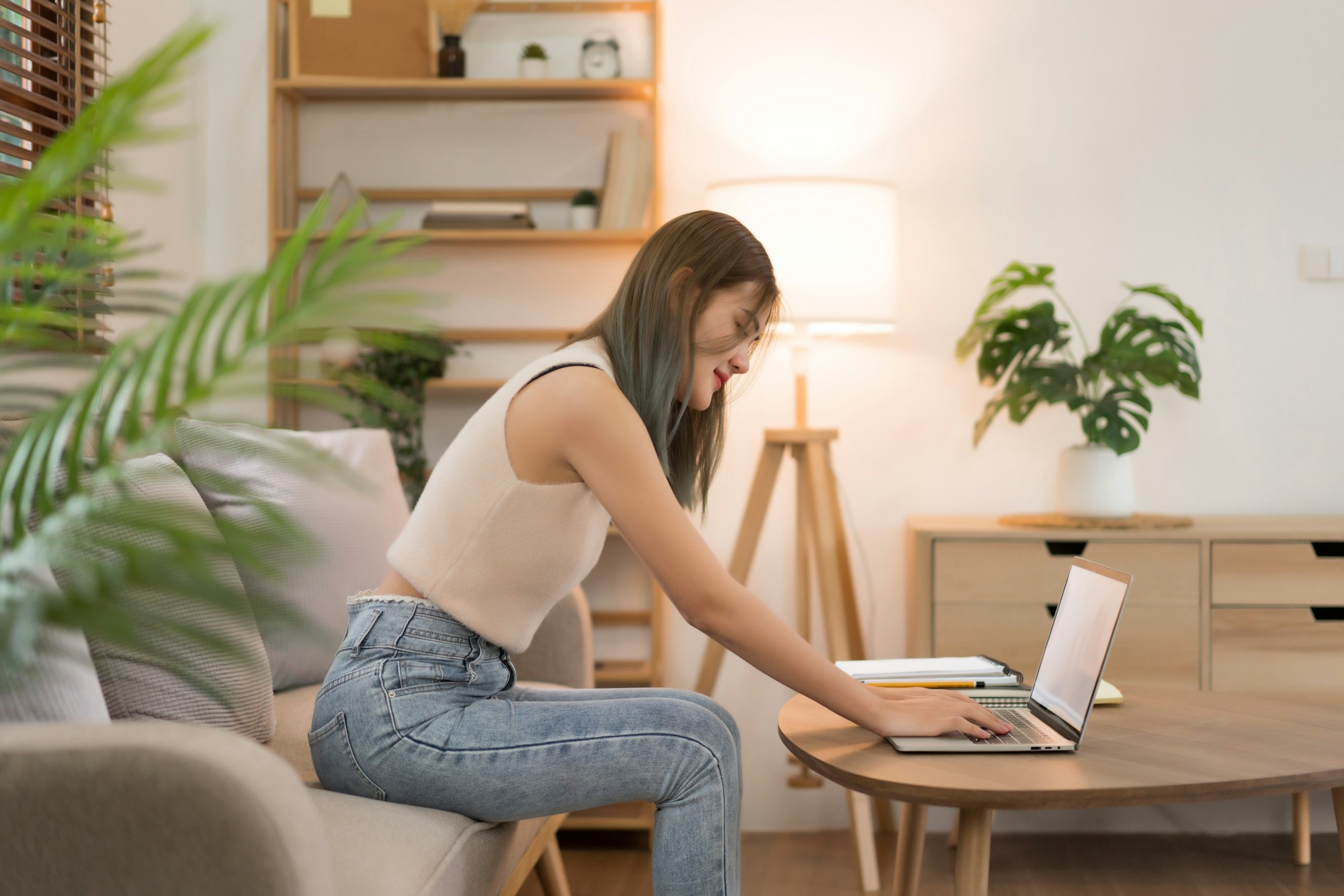 Creative design concept, Female designer sitting on couch and working to contact client in laptop